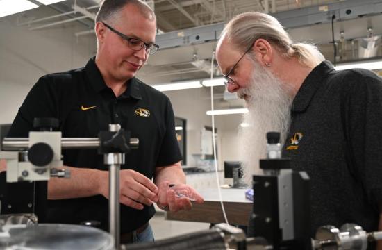 att Maschmann, left, and Tommy Sewell examine a piece of equipment in the MU Materials Science & Engineering Institute at the University of Missouri. Maschmann and Sewell are the co-directors of the institute.